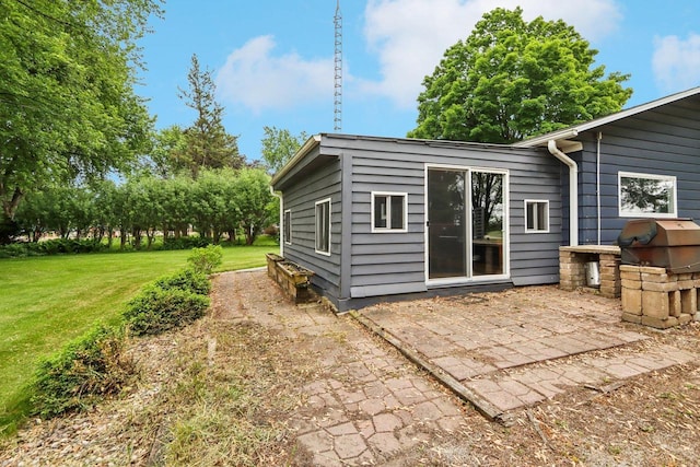 109 County Park Rd, Waupun, WI 53963 - back of house featuring a lawn and a patio