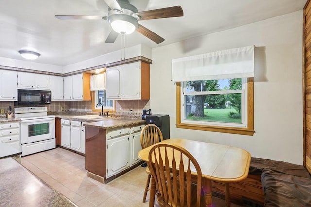 109 County Park Rd, Waupun, WI 53963 - kitchen featuring black microwave, electric stove, a sink, decorative backsplash, and a peninsula