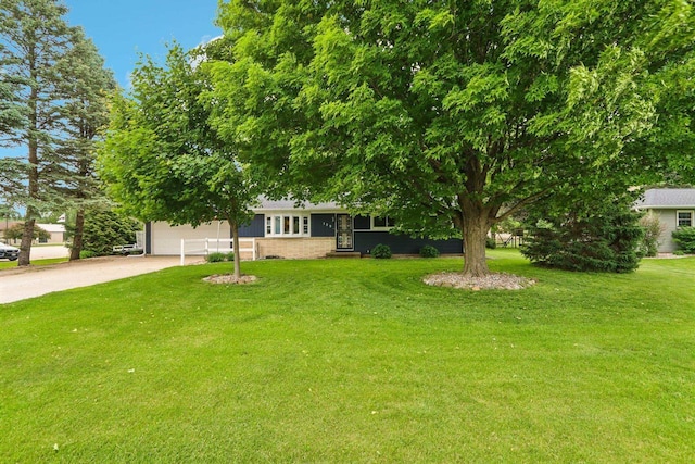 109 County Park Rd, Waupun, WI 53963 - view of front of house with dirt driveway, a garage, and a front yard
