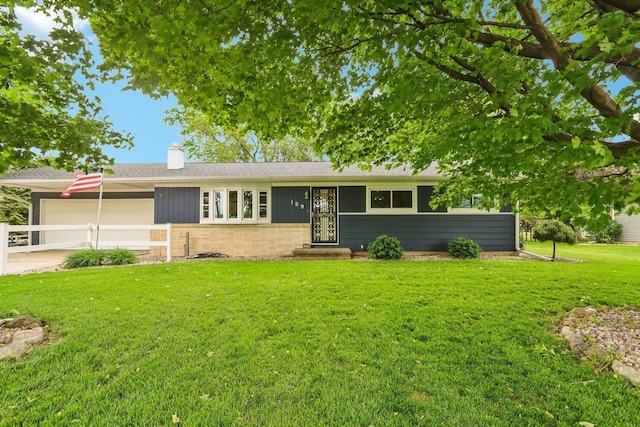 109 County Park Rd, Waupun, WI 53963 - ranch-style house featuring a front lawn, a chimney, a garage, concrete driveway, and entry steps