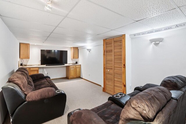 109 County Park Rd, Waupun, WI 53963 - living room featuring a drop ceiling, light colored carpet, and baseboards