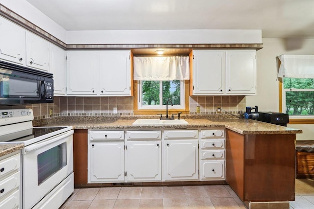 109 County Park Rd, Waupun, WI 53963 - kitchen featuring electric stove, black microwave, a sink, tasteful backsplash, and white cabinetry