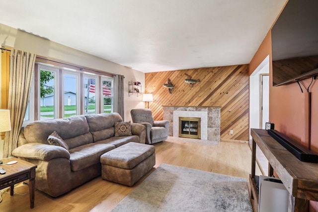 109 County Park Rd, Waupun, WI 53963 - living area with wooden walls, wood finished floors, and a glass covered fireplace