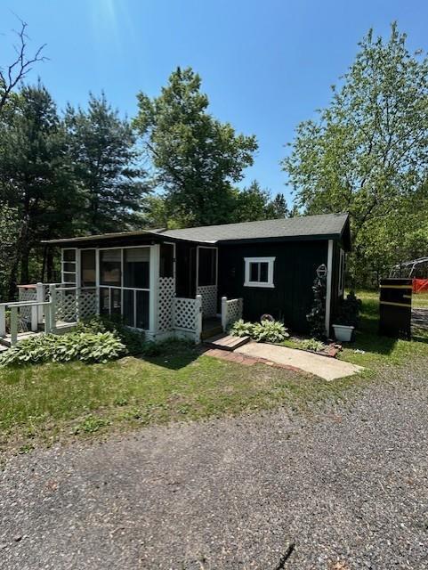 N6812 Eddy Rd, Black River Falls, WI 54615 - view of front of house with a sunroom