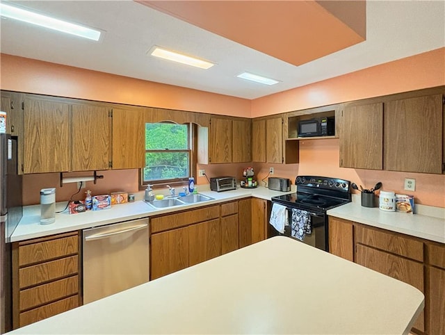 711 Cleveland Ave, Ladysmith, WI 54848 - kitchen with black appliances, a sink, light countertops, and brown cabinets