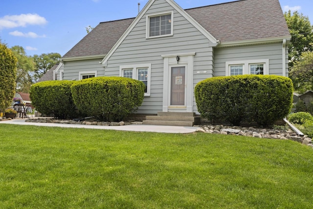 11203 W Potter Rd, Wauwatosa, WI 53226 - view of front of house featuring entry steps, a shingled roof, and a front yard