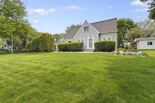 11203 W Potter Rd, Wauwatosa, WI 53226 - view of front of property with a front yard, a shingled roof, and entry steps