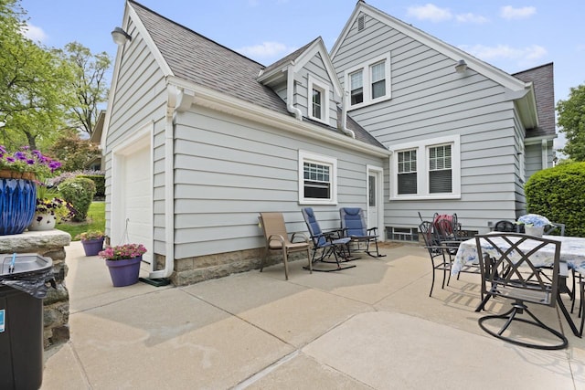 11203 W Potter Rd, Wauwatosa, WI 53226 - back of house featuring a shingled roof, a patio, and outdoor dining area