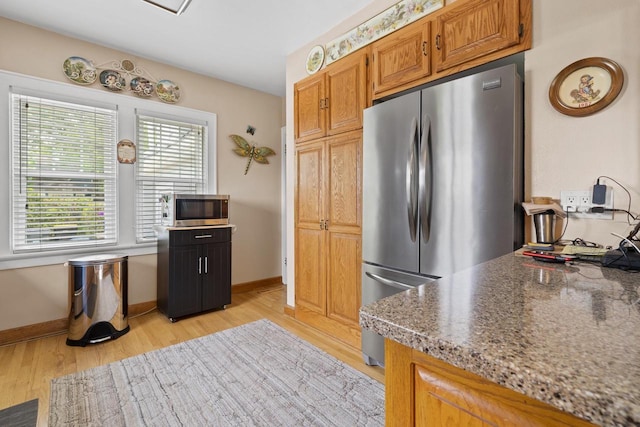 11203 W Potter Rd, Wauwatosa, WI 53226 - kitchen featuring stainless steel appliances, light wood-style floors, baseboards, and brown cabinetry