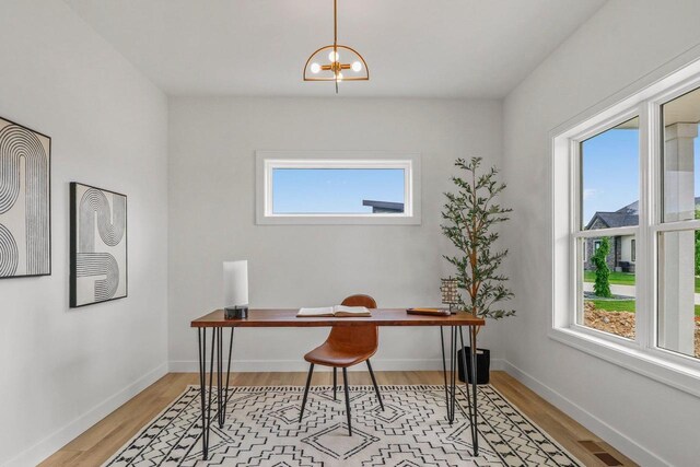 6562 Norski Ct, Windsor, WI 53598 - office space featuring light wood finished floors, a chandelier, and baseboards