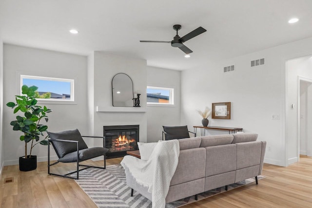 6562 Norski Ct, Windsor, WI 53598 - living area featuring ceiling fan, a glass covered fireplace, plenty of natural light, light wood finished floors, and recessed lighting