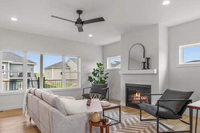 6562 Norski Ct, Windsor, WI 53598 - living area with plenty of natural light, ceiling fan, light wood-style flooring, a glass covered fireplace, and recessed lighting