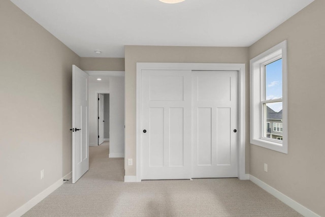 6562 Norski Ct, Windsor, WI 53598 - unfurnished bedroom featuring baseboards, light carpet, and a closet