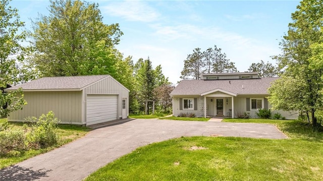 10787 Reynolds Rd, Hayward, WI 54843 - view of front of home featuring a detached garage, a front lawn, and an outbuilding