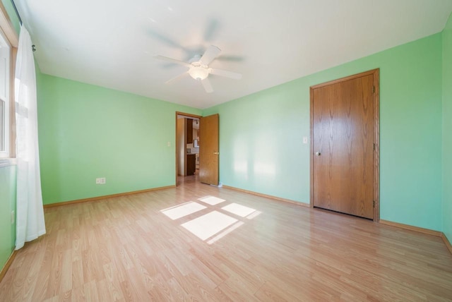 1603 Maplewood Dr, Little Chute, WI 54140 - unfurnished bedroom featuring light wood-style flooring, baseboards, and a ceiling fan