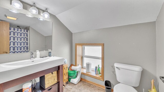 286 Ledgeview Ave, Fond Du Lac, WI 54935 - bathroom with vaulted ceiling, toilet, vanity, and tile patterned floors