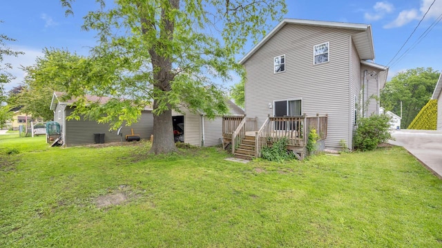 286 Ledgeview Ave, Fond Du Lac, WI 54935 - rear view of house featuring a deck, a yard, and an outbuilding