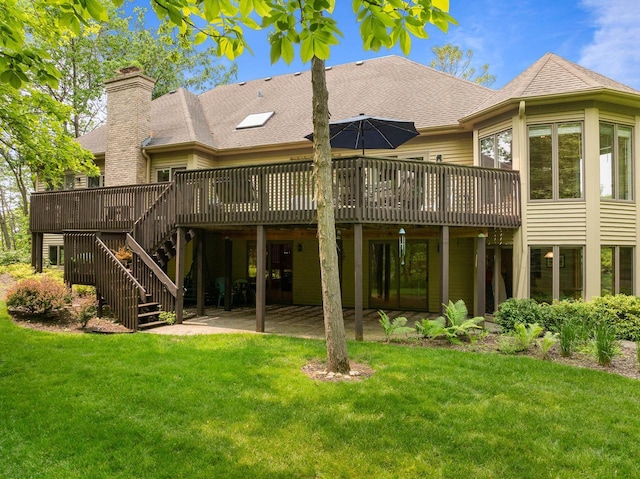 1261 Deer Ct, Lake Geneva, WI 53147 - back of property with a deck, a lawn, a shingled roof, and a chimney