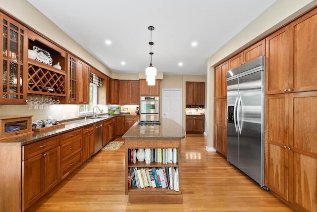 1261 Deer Ct, Lake Geneva, WI 53147 - kitchen with stainless steel appliances, open shelves, a sink, dark stone countertops, and recessed lighting