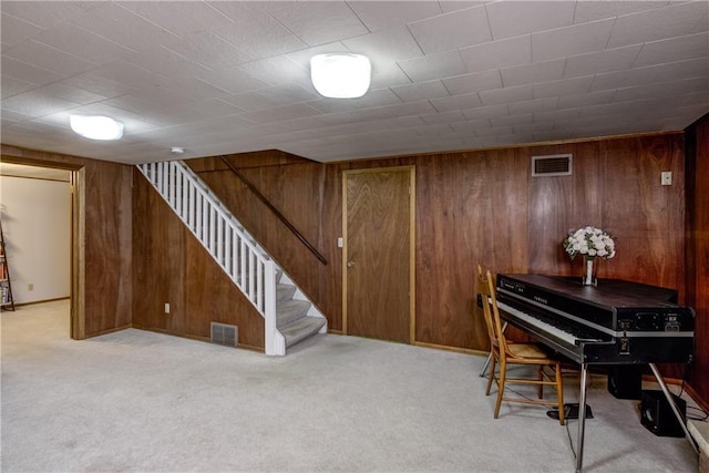 2706 Nimitz St, Eau Claire, WI 54701 - sitting room with wood walls, light colored carpet, and stairway