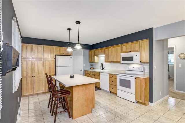2706 Nimitz St, Eau Claire, WI 54701 - kitchen with white appliances, a sink, backsplash, and light countertops