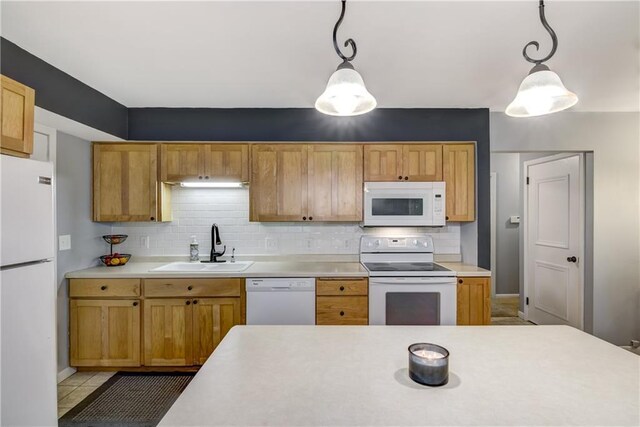 2706 Nimitz St, Eau Claire, WI 54701 - kitchen with white appliances, light countertops, a sink, and tasteful backsplash