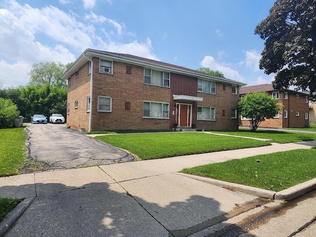 5855 N 83rd St, Milwaukee, WI 53218 - view of front of house with a front lawn, brick siding, and driveway