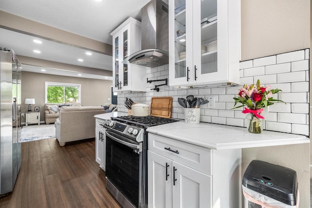 1514 S 96th St, West Allis, WI 53214 - kitchen with appliances with stainless steel finishes, wall chimney range hood, white cabinets, dark wood-type flooring, and backsplash
