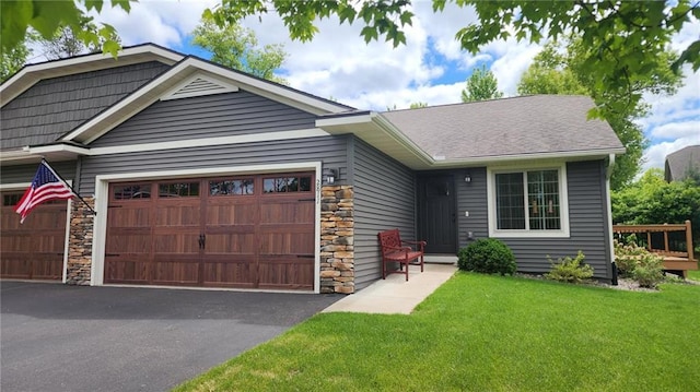 2811 Swallowtail Ct, Altoona, WI 54720 - view of front facade featuring a garage, stone siding, and a front yard
