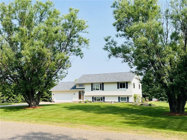 18242 48th Ave, Chippewa Falls, WI 54729 - view of front of house featuring an attached garage, a front yard, and driveway