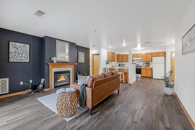 1972 Parknoll Ln, Port Washington, WI 53074 - living area featuring wood finished floors, a glass covered fireplace, and baseboards