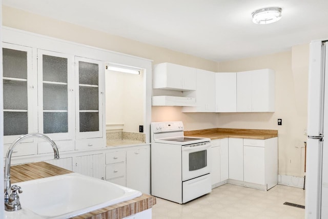103 First St, Ontario, WI 54651 - kitchen featuring white appliances, a sink, white cabinets, light countertops, and glass insert cabinets