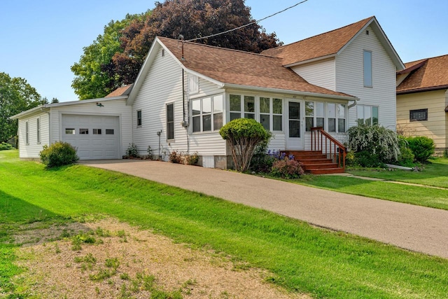 103 First St, Ontario, WI 54651 - traditional-style home featuring a shingled roof, concrete driveway, a front yard, and an attached garage