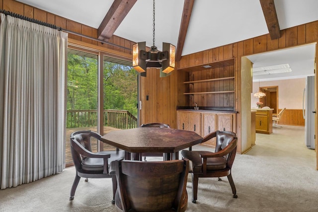 15075 Kings Ridge Ct, Brookfield, WI 53005 - dining area with a chandelier, wooden walls, light carpet, beamed ceiling, and built in shelves