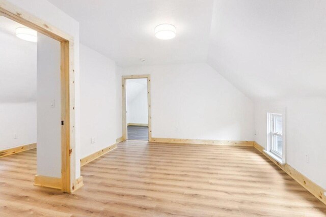 2533 S Austin St, Milwaukee, WI 53207 - additional living space featuring light wood-style flooring, vaulted ceiling, and baseboards
