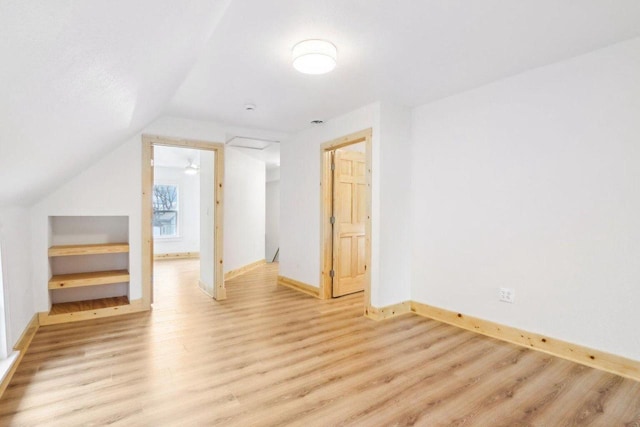 2533 S Austin St, Milwaukee, WI 53207 - additional living space with light wood finished floors, baseboards, and lofted ceiling