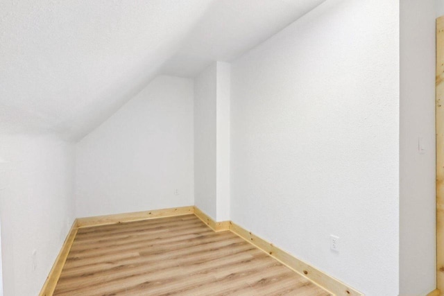 2533 S Austin St, Milwaukee, WI 53207 - additional living space with lofted ceiling, light wood finished floors, and baseboards