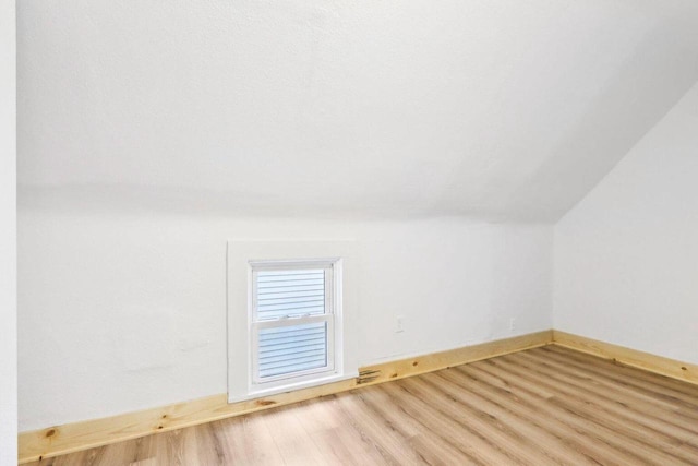 2533 S Austin St, Milwaukee, WI 53207 - additional living space with wood finished floors, vaulted ceiling, and baseboards