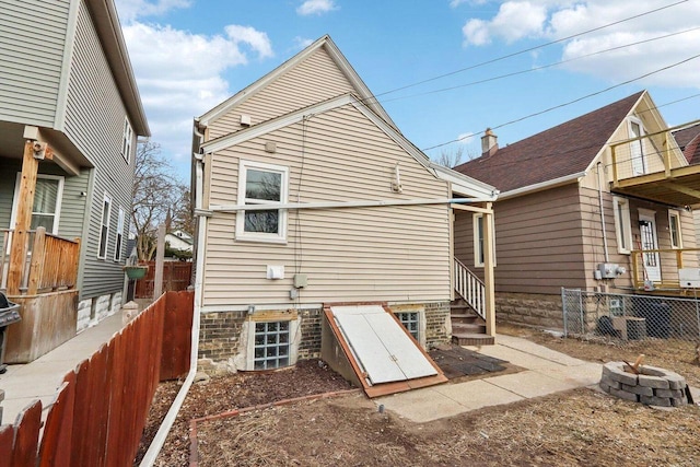 2533 S Austin St, Milwaukee, WI 53207 - rear view of property with an outdoor fire pit and a fenced backyard