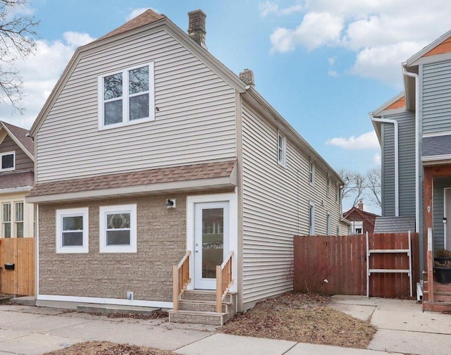 2533 S Austin St, Milwaukee, WI 53207 - view of front of property with entry steps, a chimney, and roof with shingles
