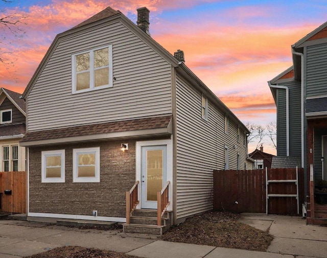 2533 S Austin St, Milwaukee, WI 53207 - view of front facade featuring entry steps, a chimney, and roof with shingles
