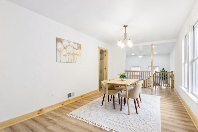 2533 S Austin St, Milwaukee, WI 53207 - dining space featuring baseboards, a chandelier, light wood finished floors, and ceiling fan