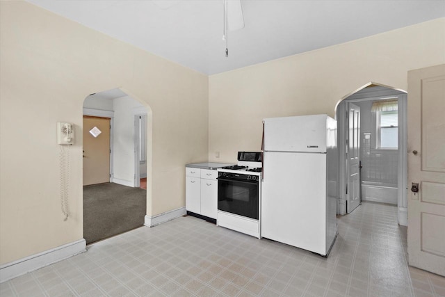 3700 E Hammond Ave, Cudahy, WI 53110 - kitchen featuring gas stove, freestanding refrigerator, arched walkways, and baseboards