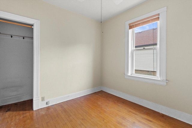 3700 E Hammond Ave, Cudahy, WI 53110 - unfurnished bedroom with baseboards, light wood-style floors, and a closet