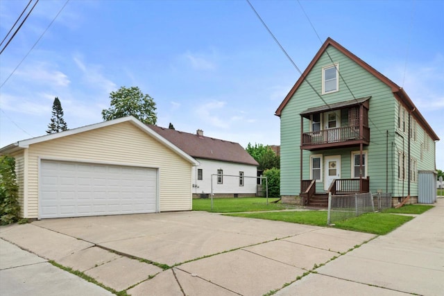 3700 E Hammond Ave, Cudahy, WI 53110 - view of front of home with a balcony, a detached garage, and a front lawn