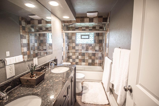 8561 N Greenvale Rd, Bayside, WI 53217 - full bath with toilet, double vanity, a textured wall, bath / shower combo with glass door, and recessed lighting
