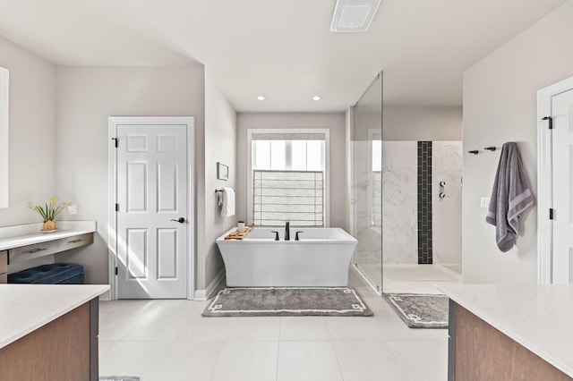 N56W27213 Crispin Ct, Lisbon, WI 53089 - bathroom with a freestanding bath, tiled shower, tile patterned flooring, baseboards, and recessed lighting