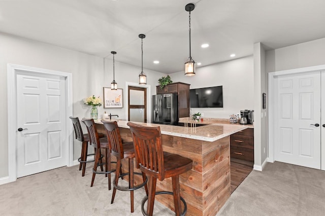 N56W27213 Crispin Ct, Lisbon, WI 53089 - kitchen featuring stainless steel fridge with ice dispenser, light carpet, a kitchen breakfast bar, a peninsula, and recessed lighting