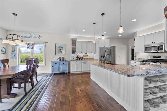5119 Reynolds Ave, Waunakee, WI 53597 - kitchen featuring appliances with stainless steel finishes, a sink, light stone countertops, dark wood-style floors, and recessed lighting