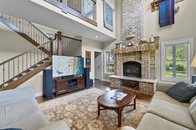 5119 Reynolds Ave, Waunakee, WI 53597 - living room with healthy amount of natural light, a towering ceiling, wood finished floors, baseboards, and stairway